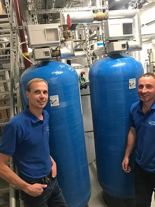 This Minimax block salt softener is installed with drinking water filter in a kitchen double cabinet. The filter to the left of the unit supplies softened filtered water to the main kitchen tap